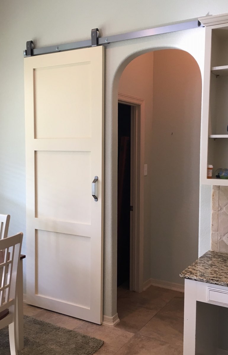 Contemporary style barn door in New Brunswick kitchen.